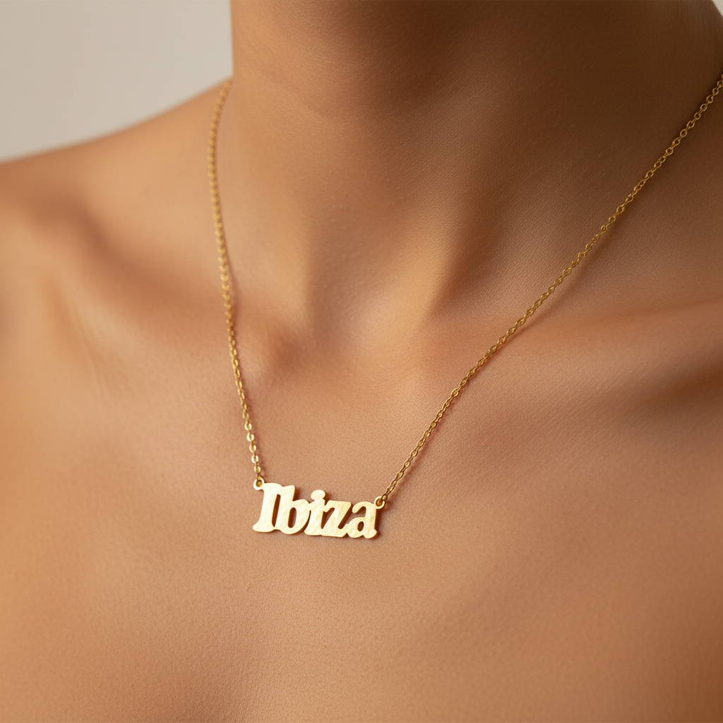 Gold necklace with 'Ibiza' pendant on a person's neck
